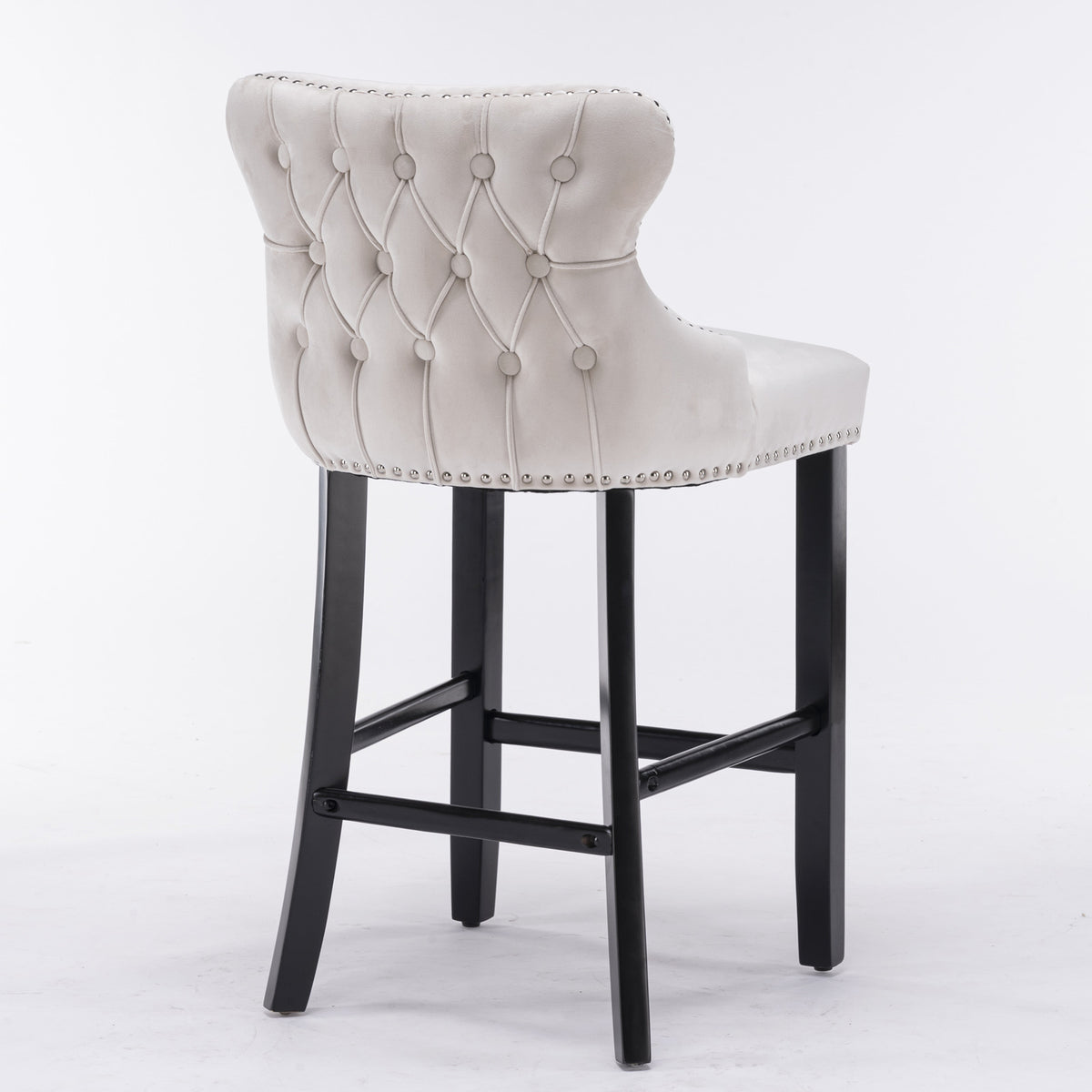 Gray tufted bar stool with black legs on a white background
