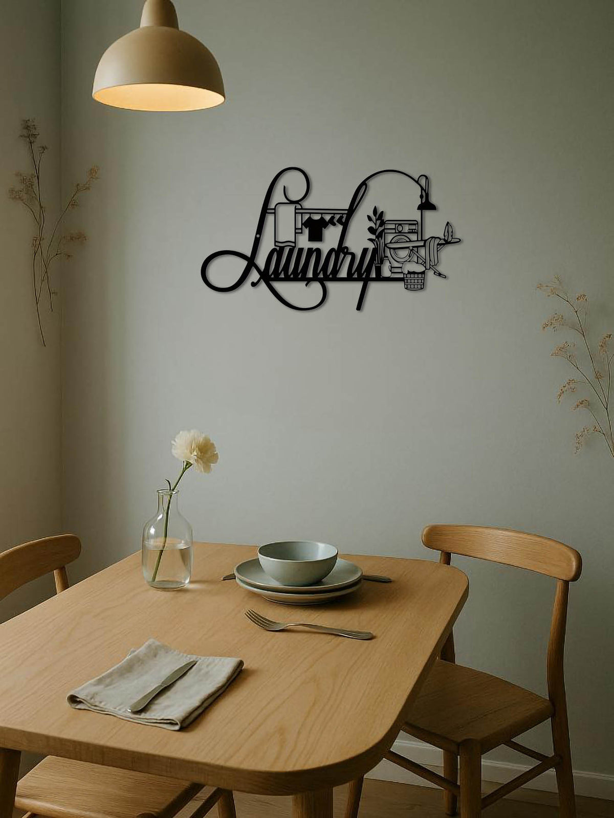 Dining room with a 'Laundry' wall decal above a table set for dinner.
