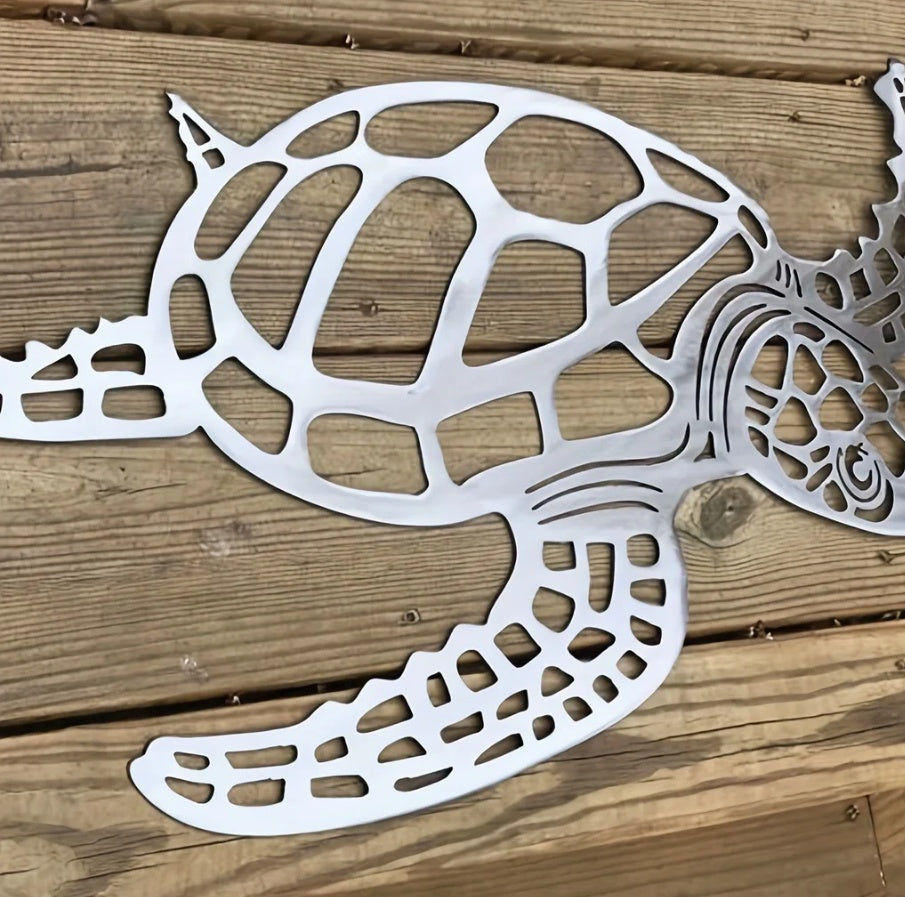 Metal turtle sculpture on a wooden surface