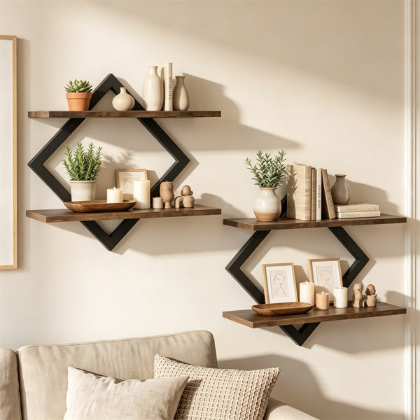 Three dark brown wooden floating shelves with black geometric diamond-shaped brackets are mounted on a beige wall above a light beige sofa. The shelves are styled with books, vases, candles, and small potted plants.