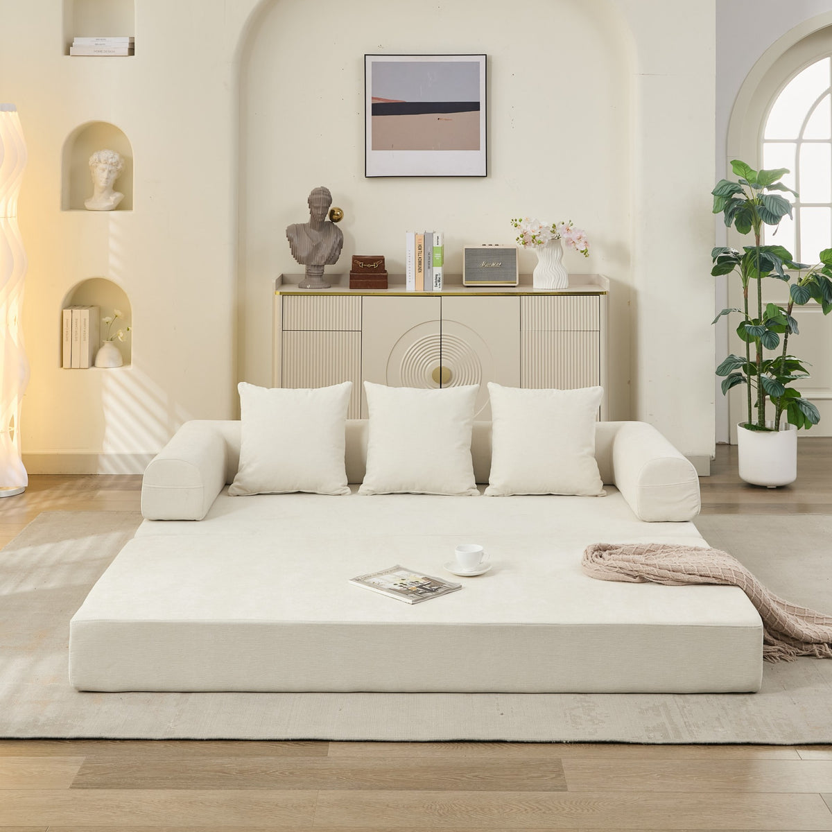 Modern living room with a white sofa and decorative items.