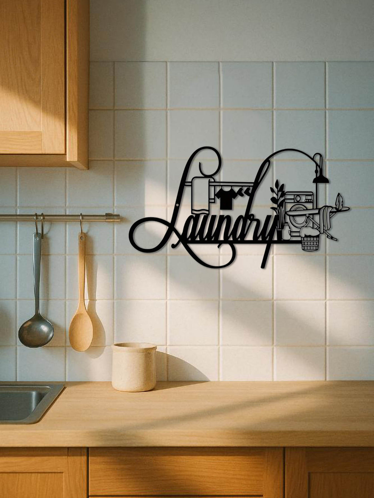 Decorative metal sign with 'Laundry' on a kitchen wall with wooden cabinets and tiled backsplash.